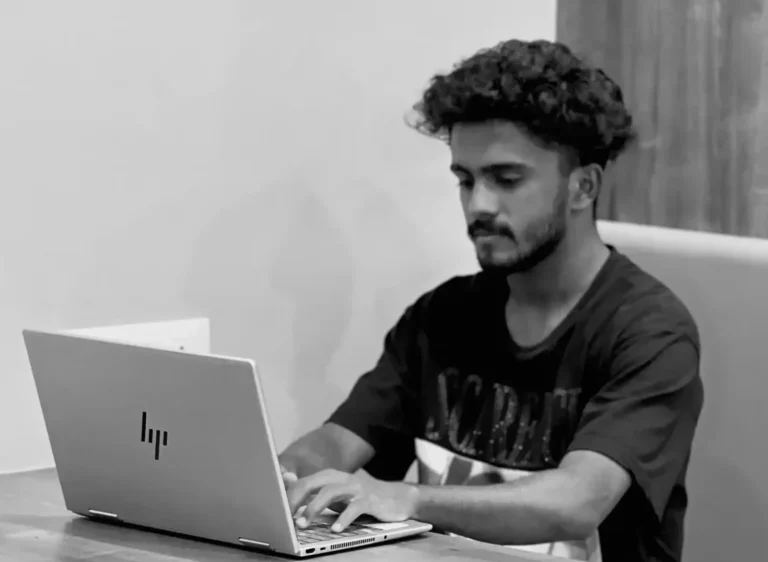 A boy is sitting with lap top is professional best digital marketer in malappuram